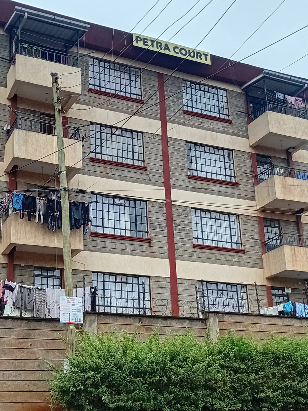 Multi-story residential building facade with balconies and signage