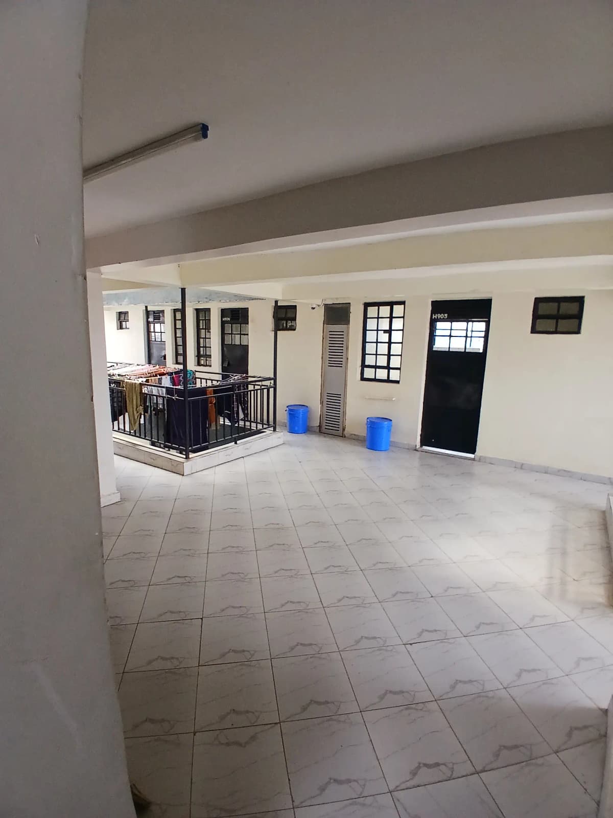 Spacious lobby with tiled flooring and multiple entry doors