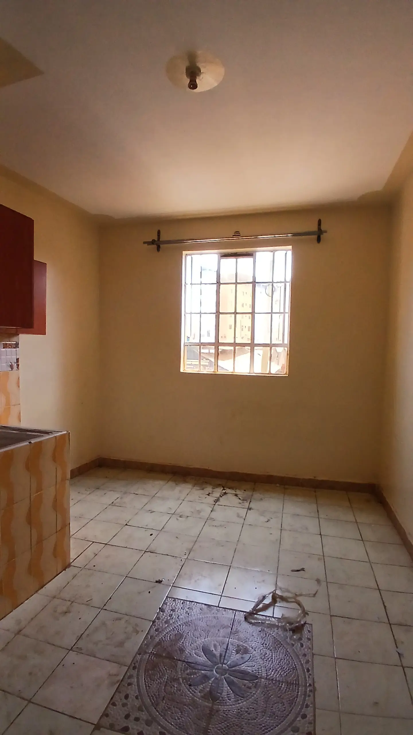 Simple kitchen with tiled floor and window light