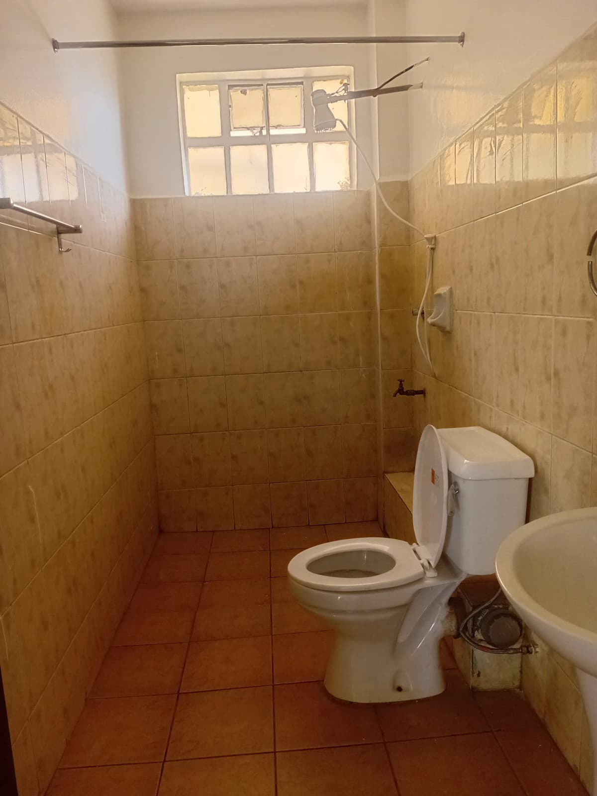 Bathroom with toilet, sink, shower enclosure and window