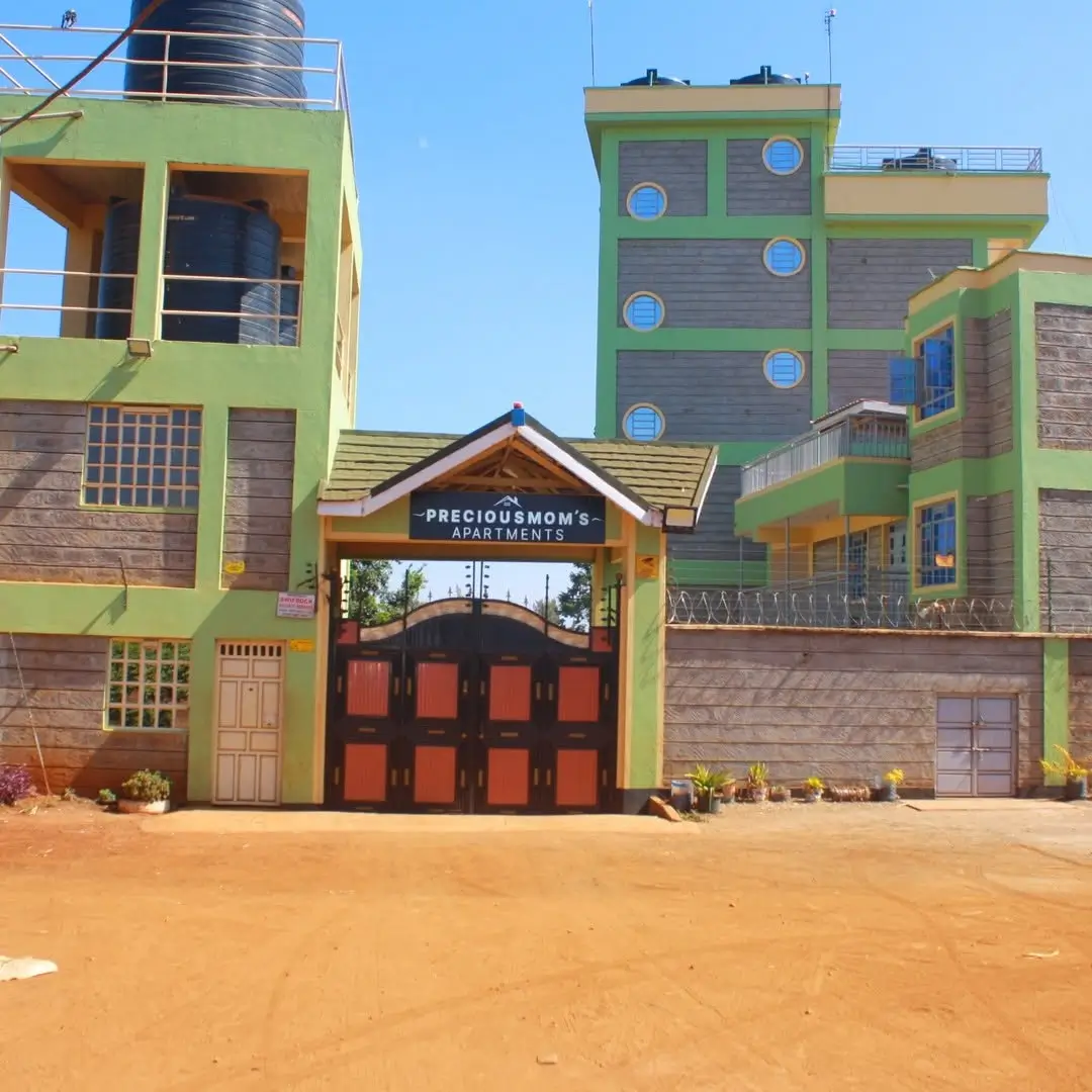 Colorful multi-story residential building with red gate entrance