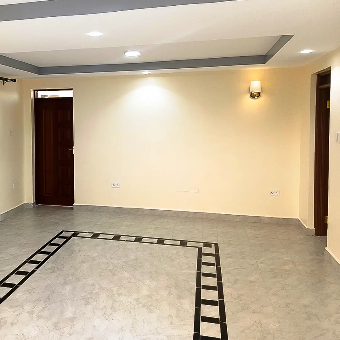 Empty living room with recessed ceiling and polished concrete floors