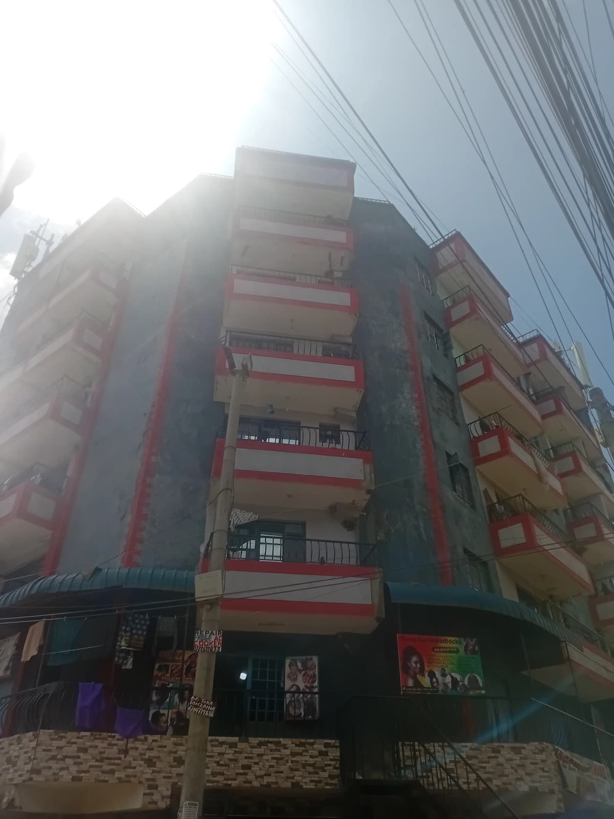 Multi-story residential building with red and yellow facade