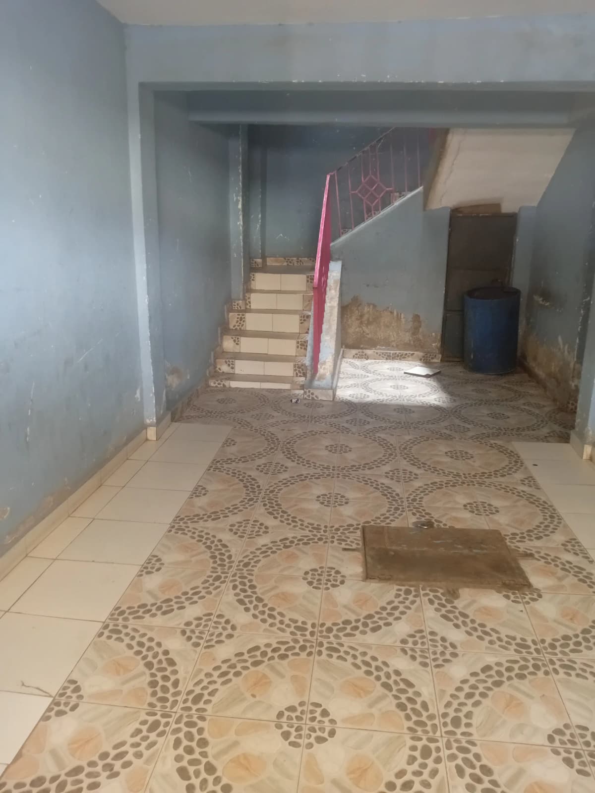 Ground floor lobby with staircase and patterned tile flooring