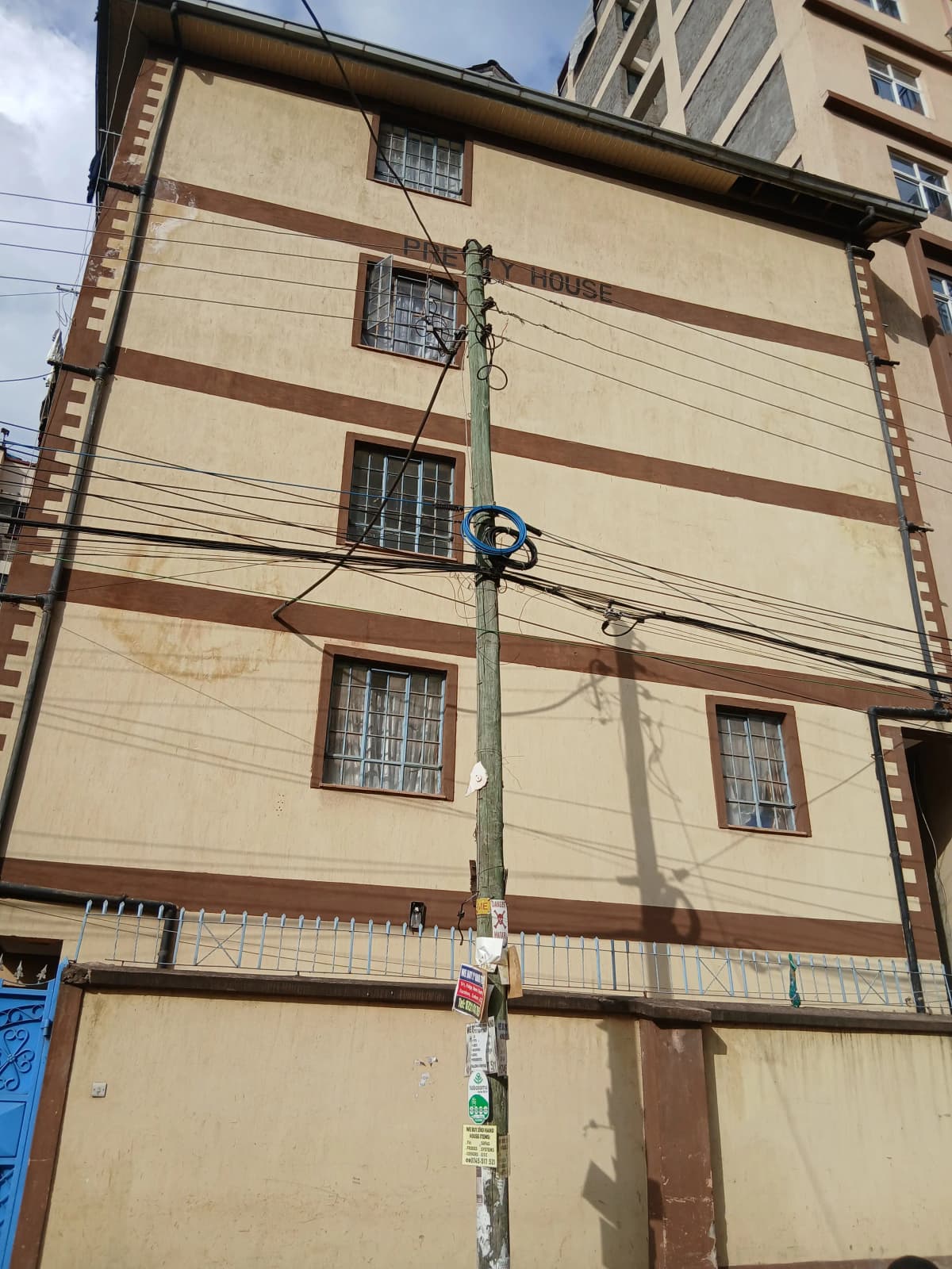 Multi-story residential building facade with horizontal stripes