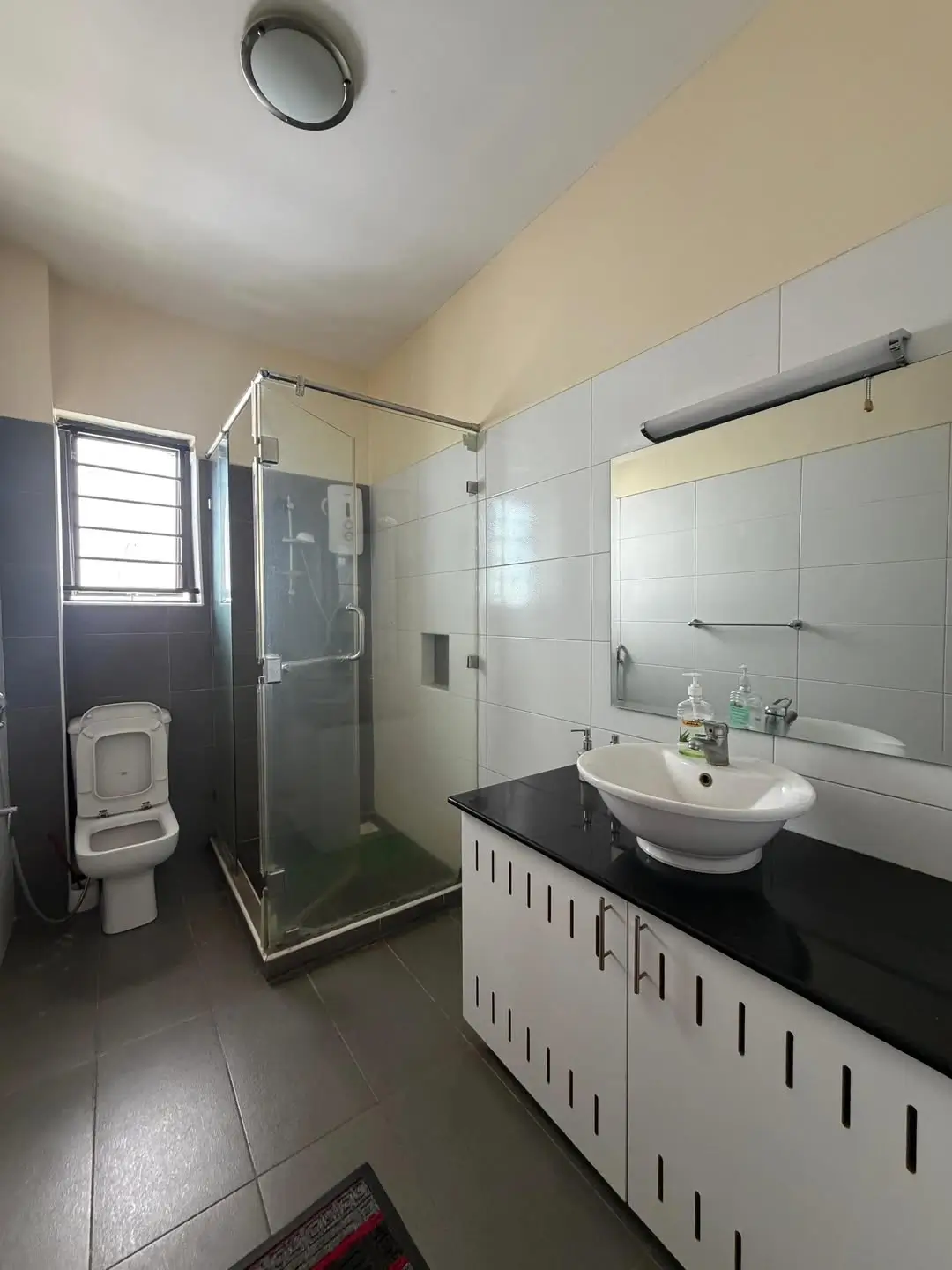 Modern bathroom with shower enclosure, vanity sink, mirror