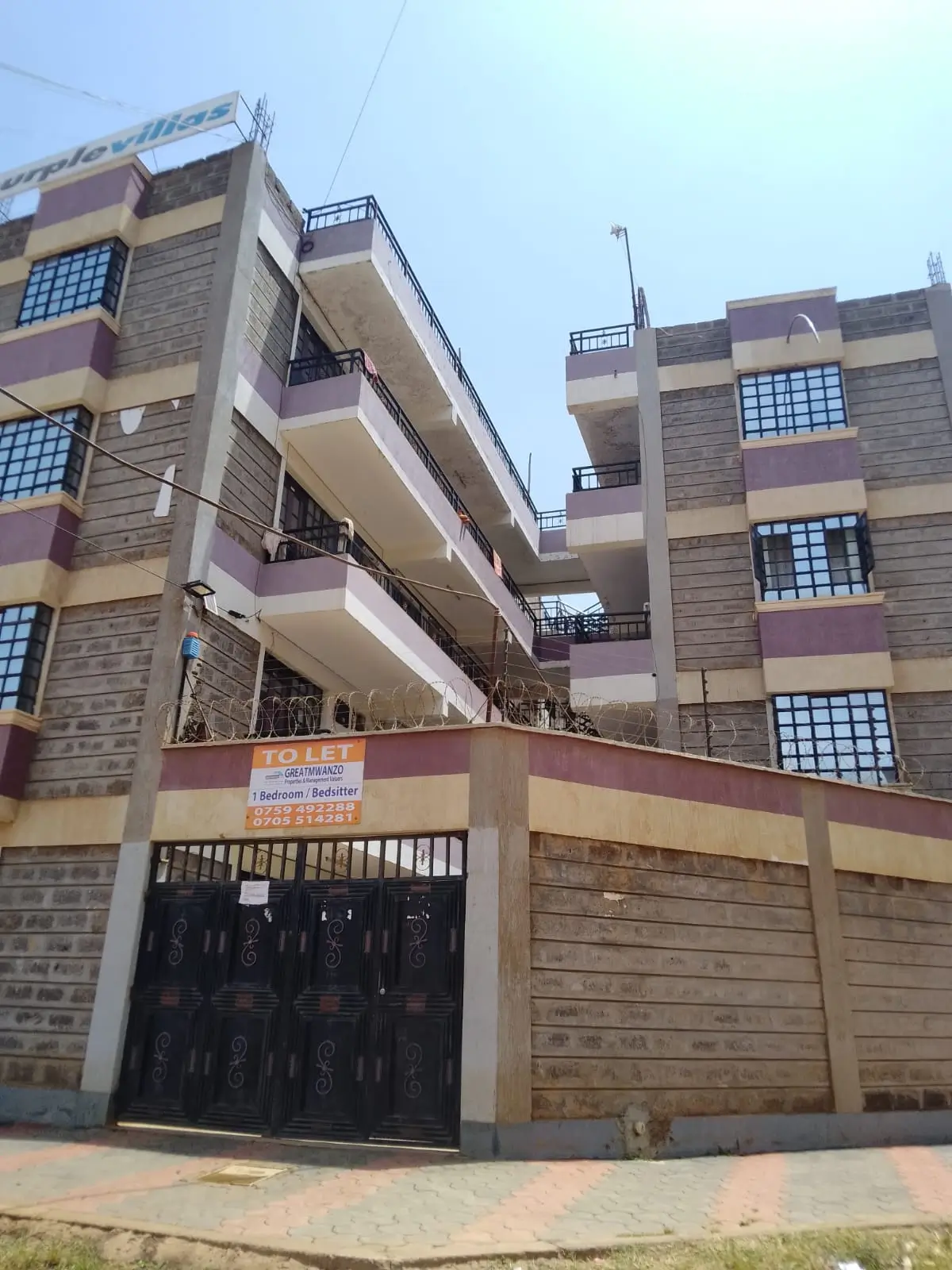 Multi-story residential building with gated compound entrance