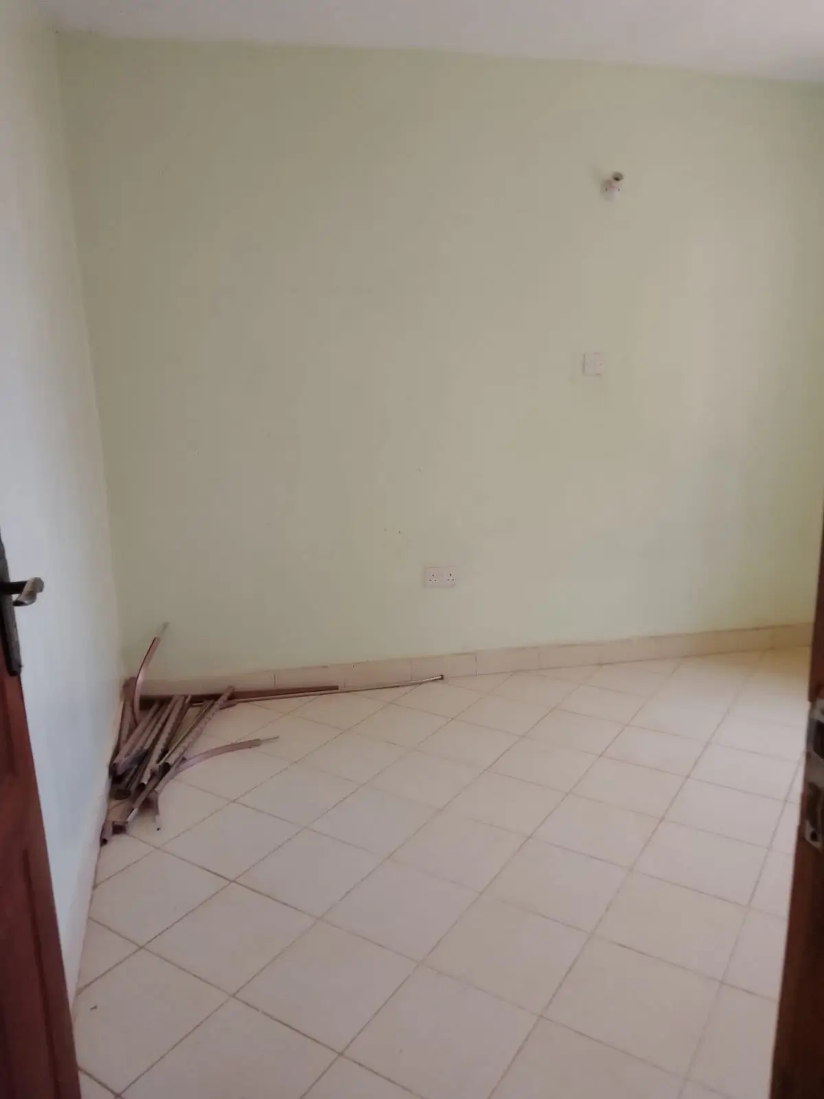 Empty bedroom with tiled flooring and bare walls