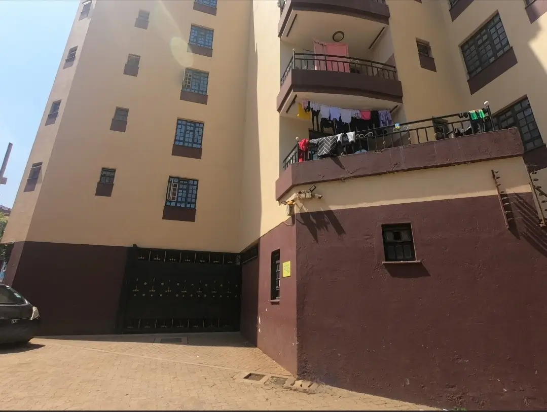 Multi-story residential building facade with parking entrance