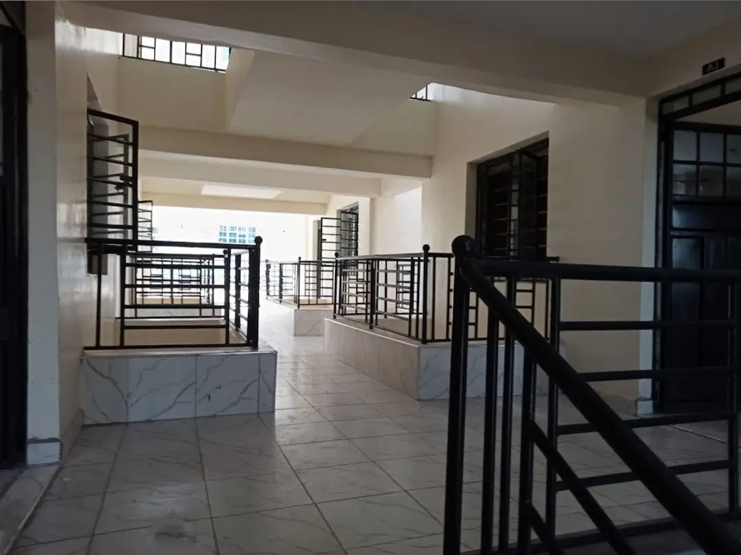 Bright multi-level lobby with marble railings and skylight