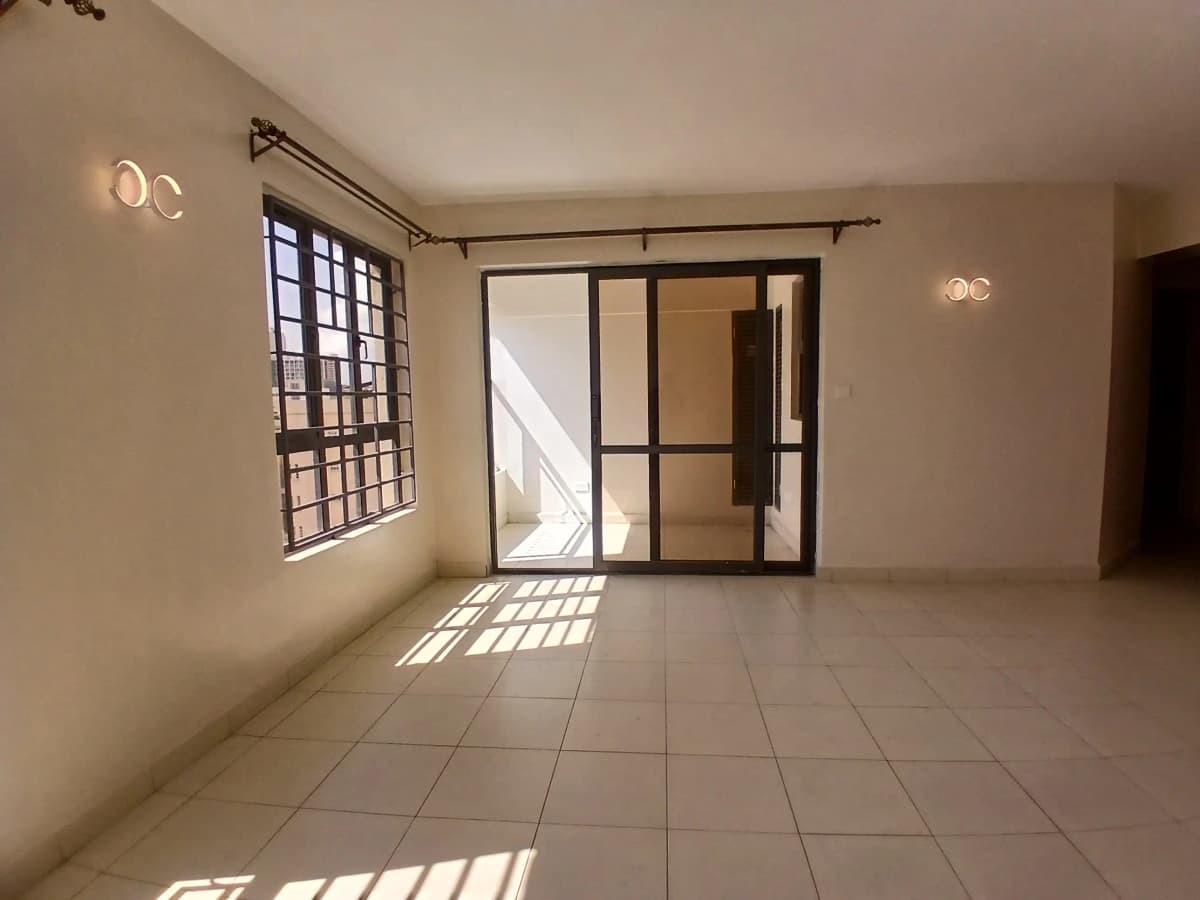Bright empty living room with tiled floor and glass doors