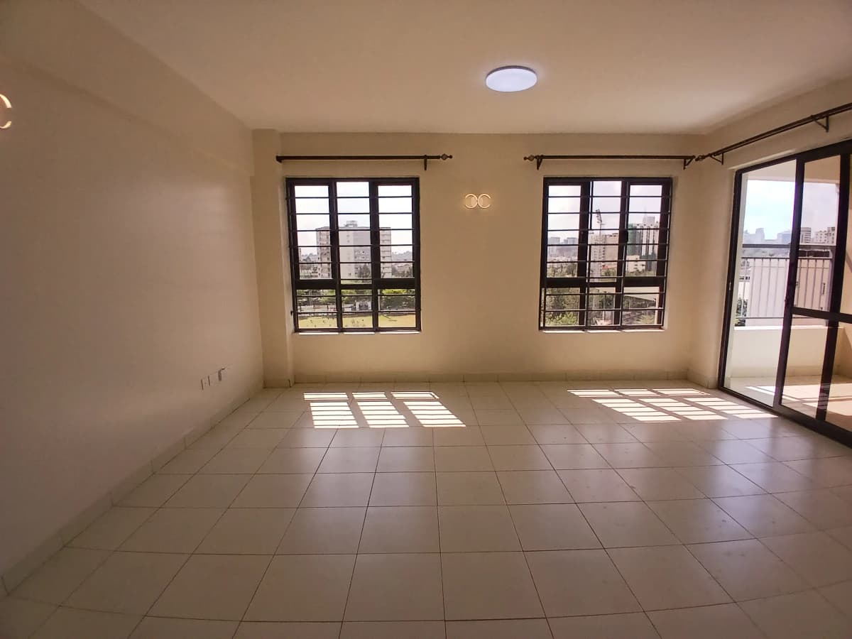 Spacious bright living room with tile flooring and multiple windows