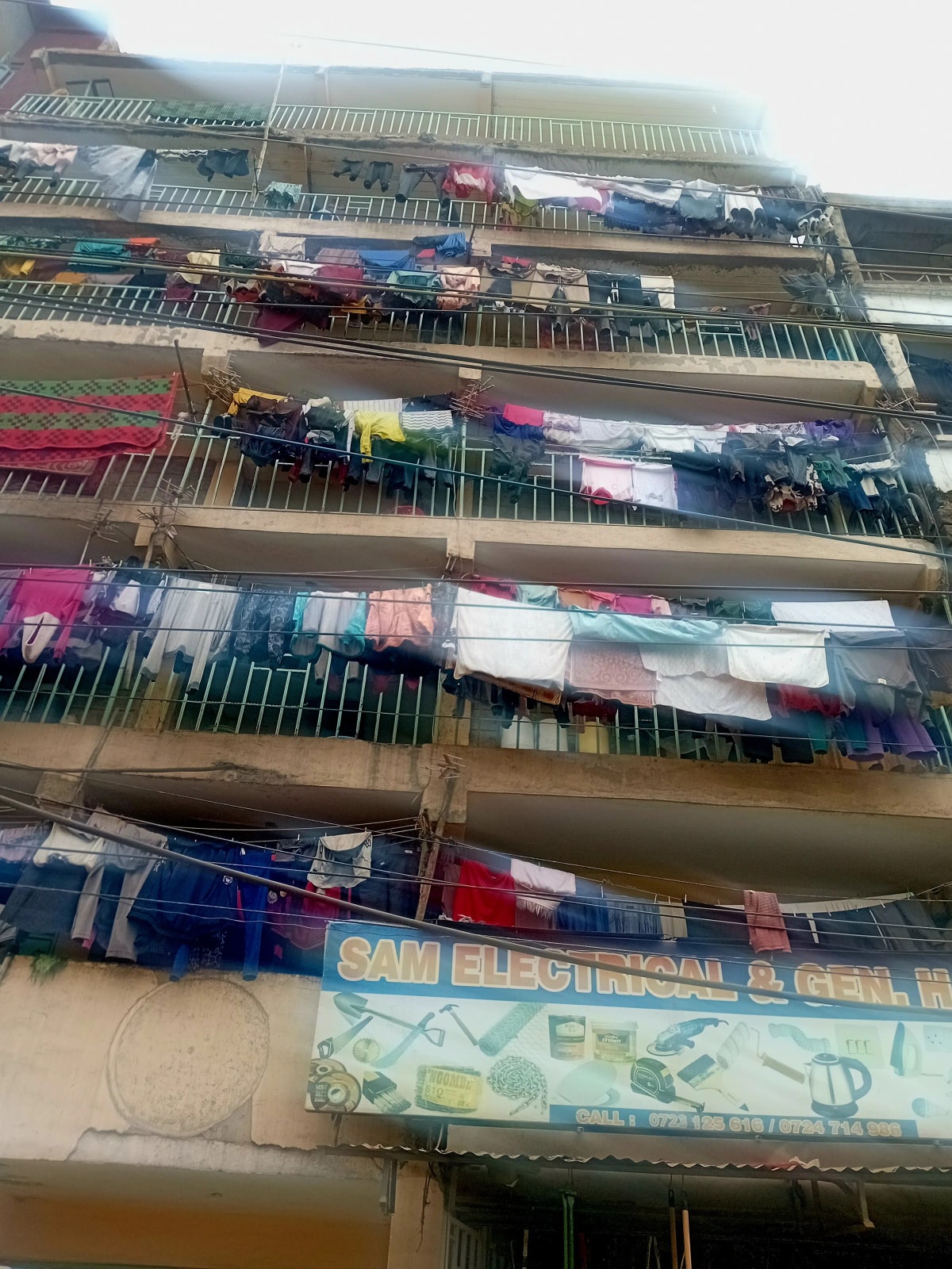 Multi-story residential building facade with laundry hanging