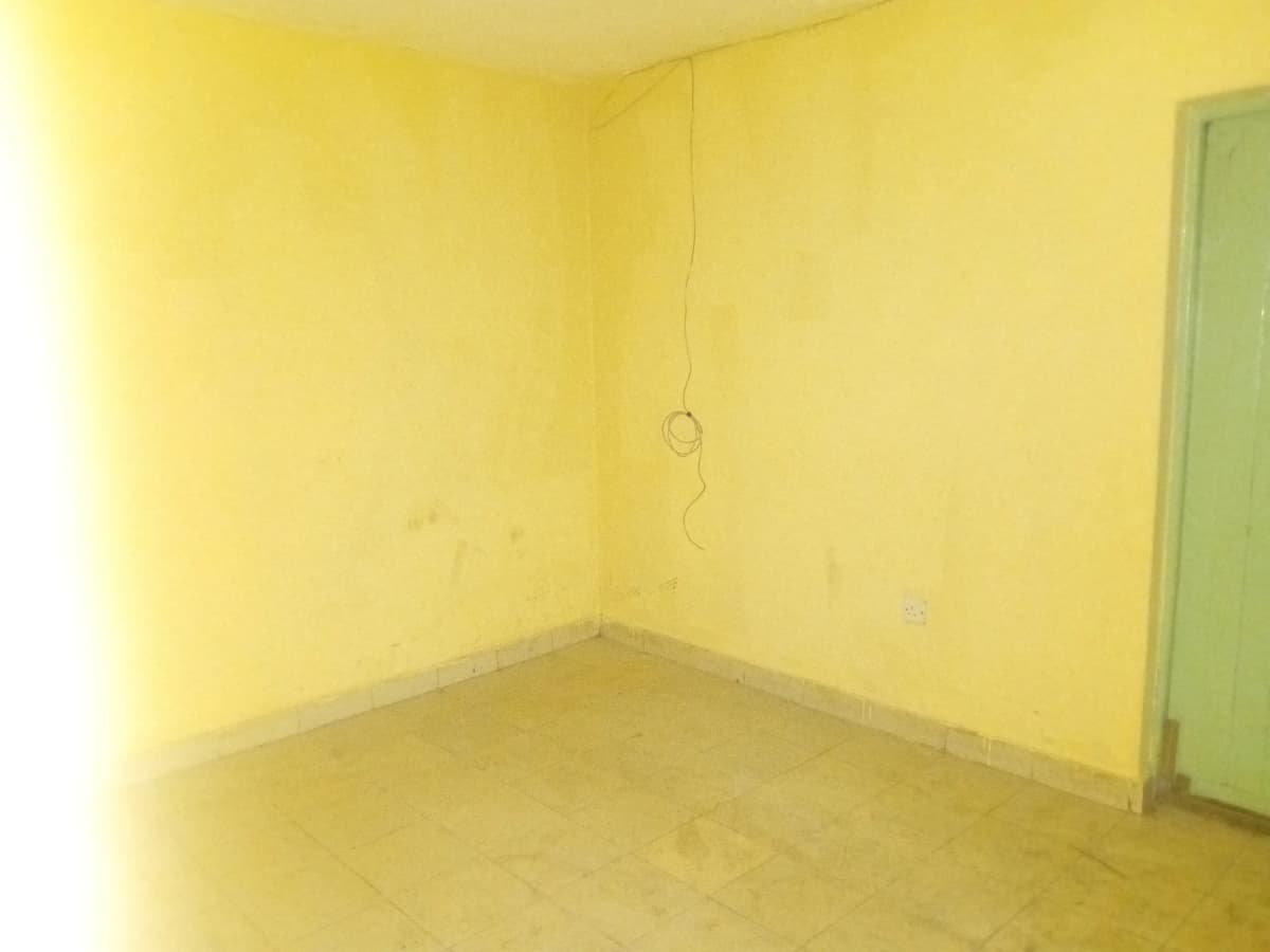 Empty room with yellow walls and green door frame