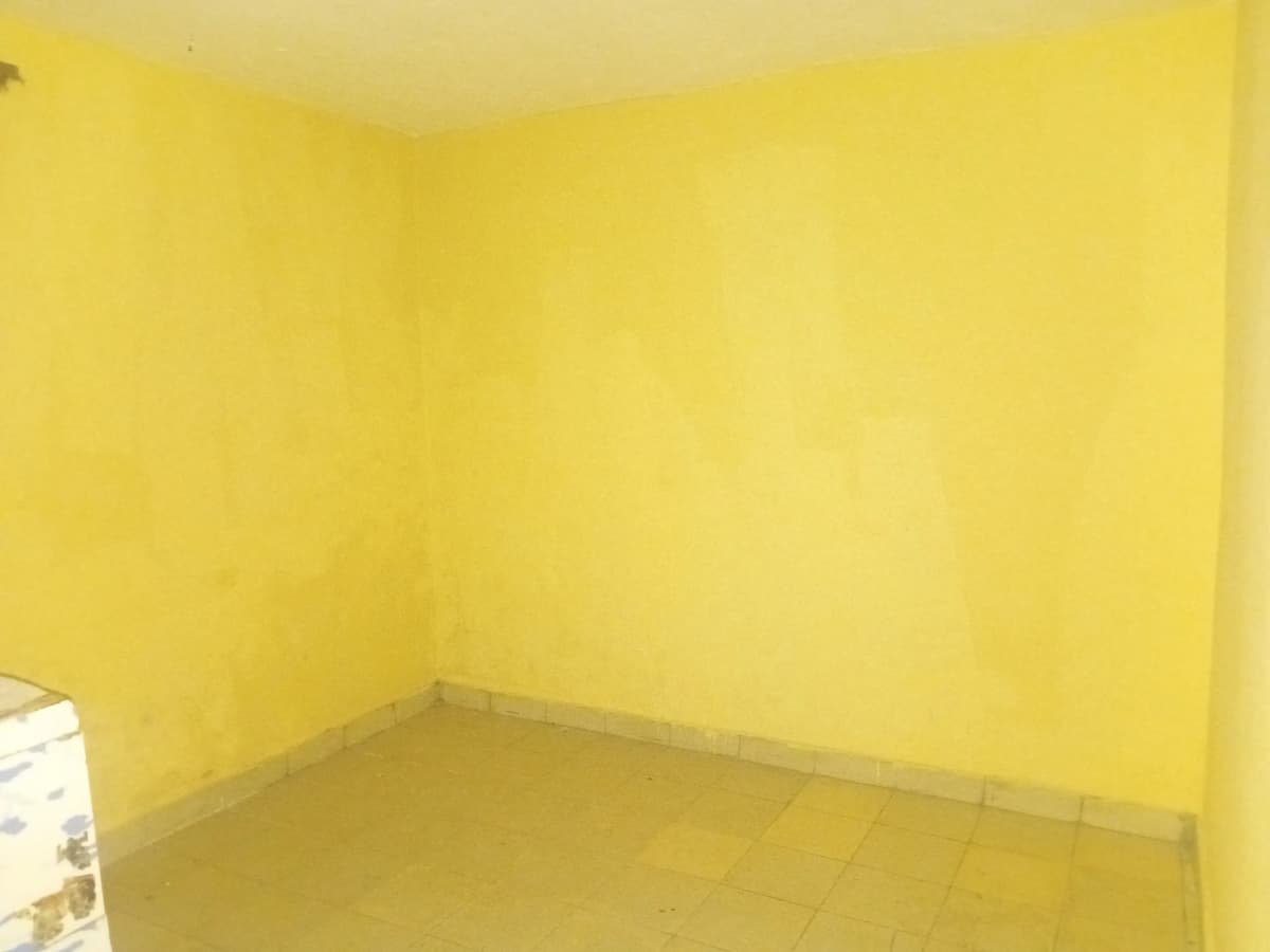 Empty room with bright yellow walls and bare floor