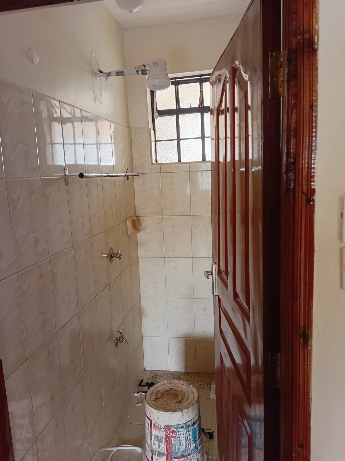 Compact bathroom with walk-in shower and small window