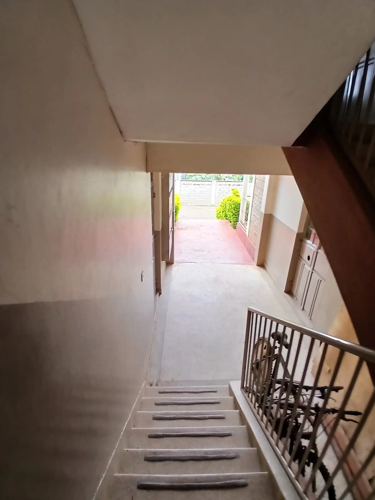 Bright corridor with staircase leading to outdoor entrance