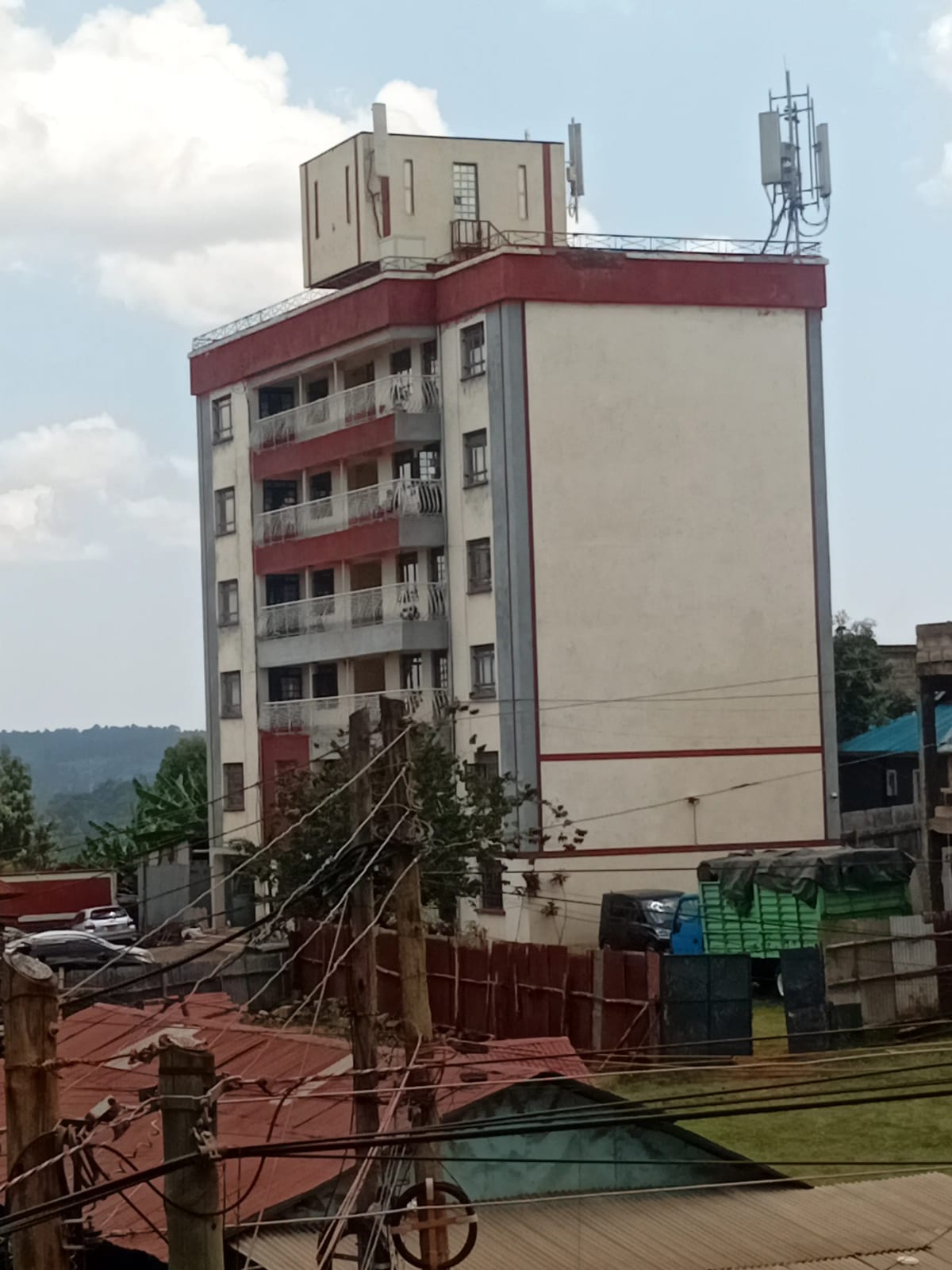Multi-story residential building facade with red and white exterior