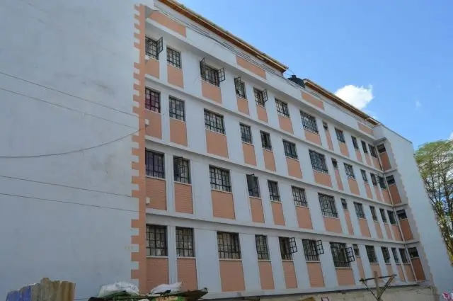 Multi-story residential building facade with orange and white striping
