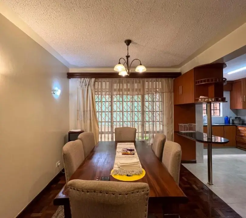 Formal dining room with wooden table and upholstered chairs