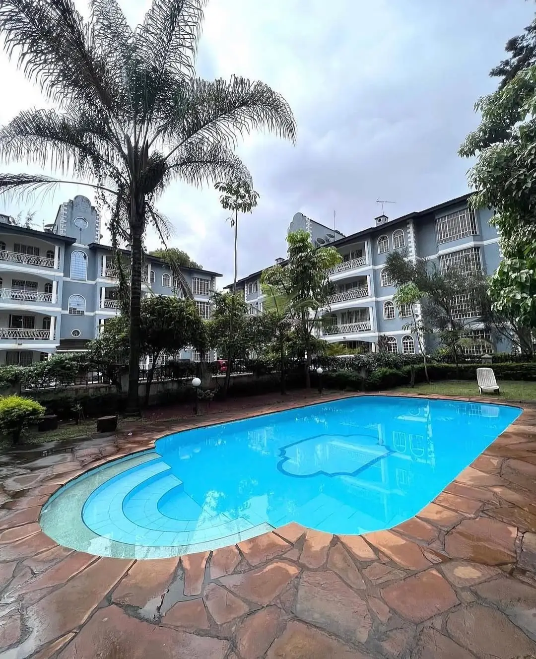 Resort-style swimming pool with kidney shape and surrounding patio