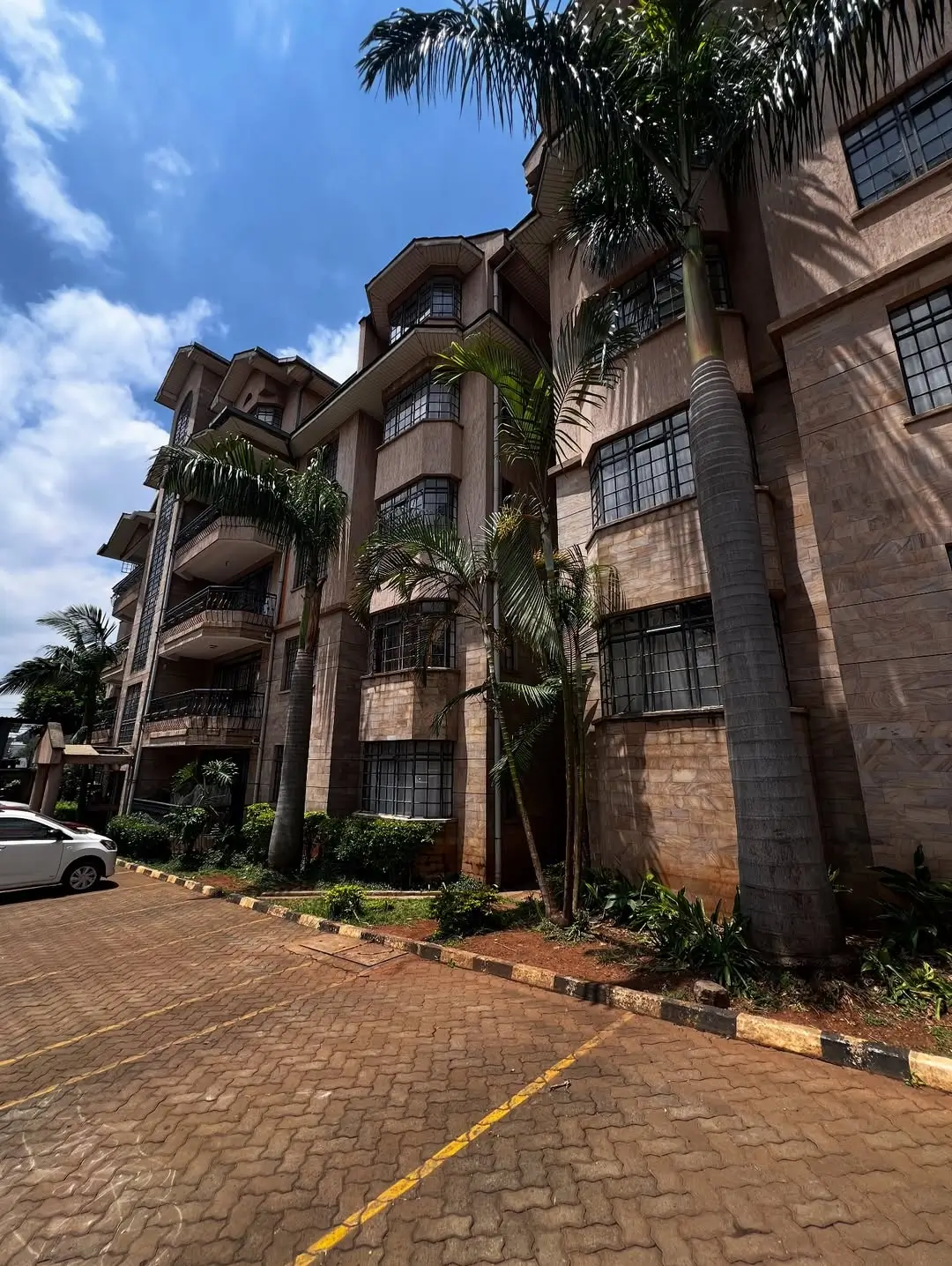 Multi-story residential building facade with brick exterior and balconies