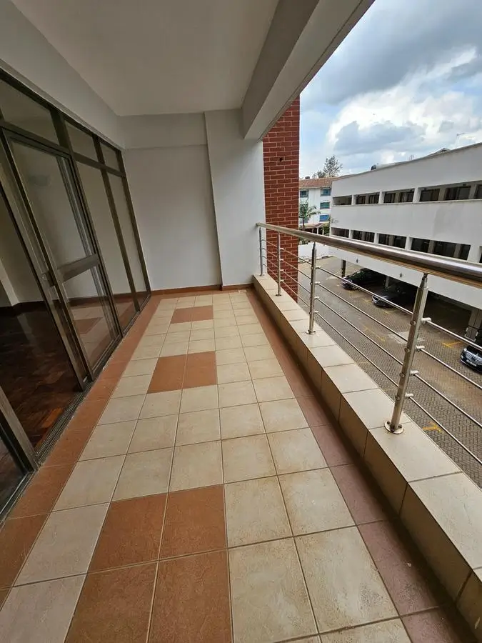 Spacious balcony with tile flooring and city views
