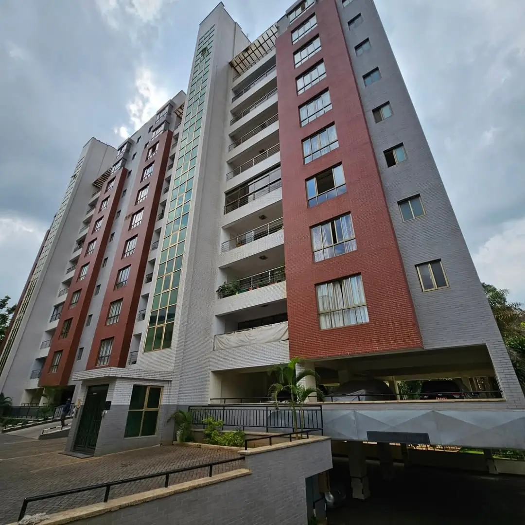Modern multi-story residential building with red brick facade