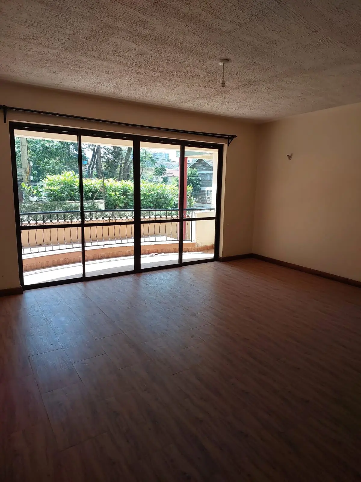 Spacious living room with large glazed doors overlooking garden