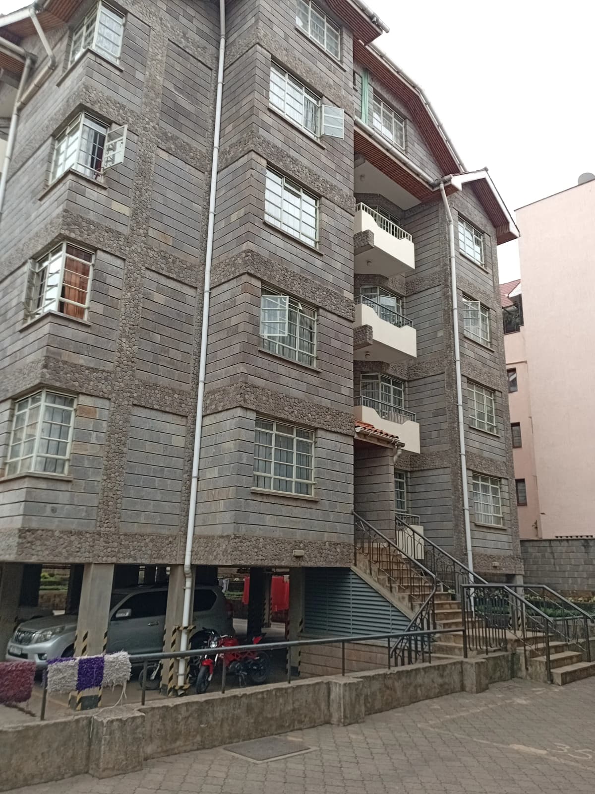 Multi-story apartment building facade with stone exterior