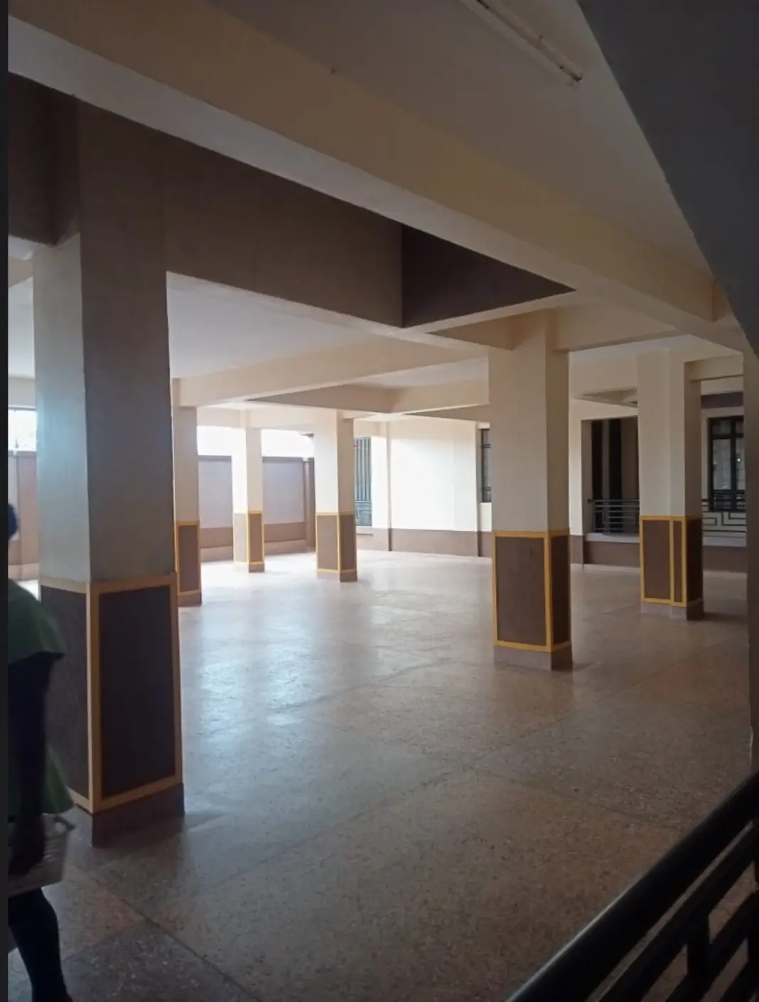 Spacious lobby with polished floors and supporting columns