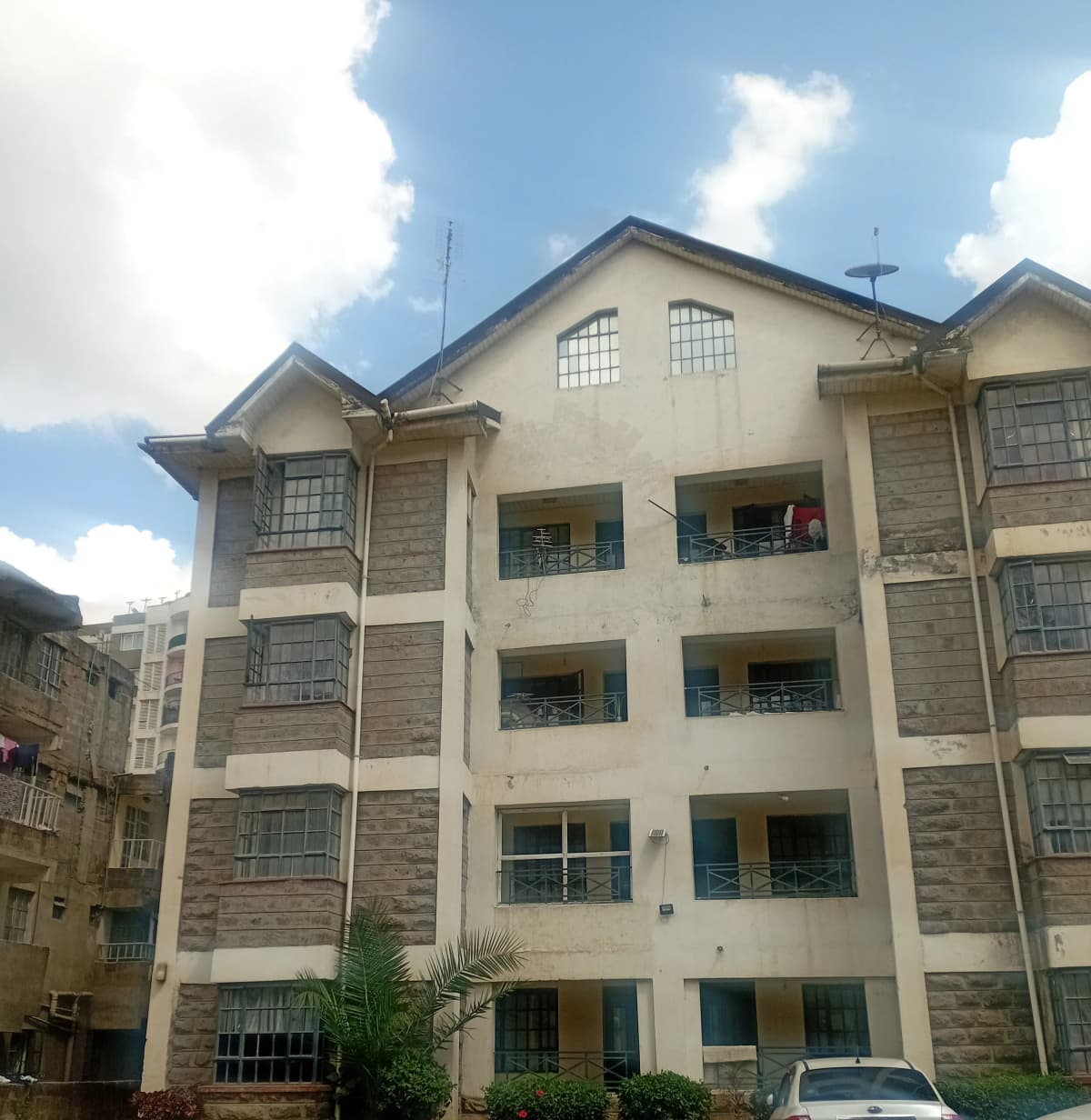 Multi-story residential building facade with balconies and windows