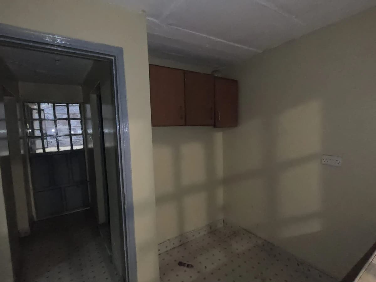 Unfurnished kitchen space with brown wall cabinets