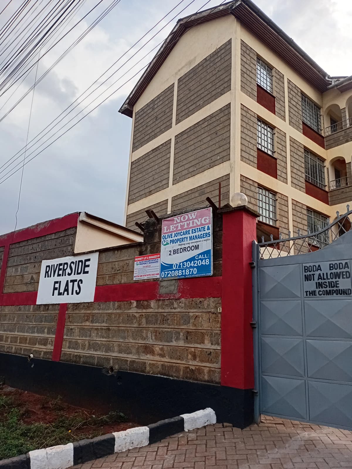 Multi-story residential building with compound gate entrance