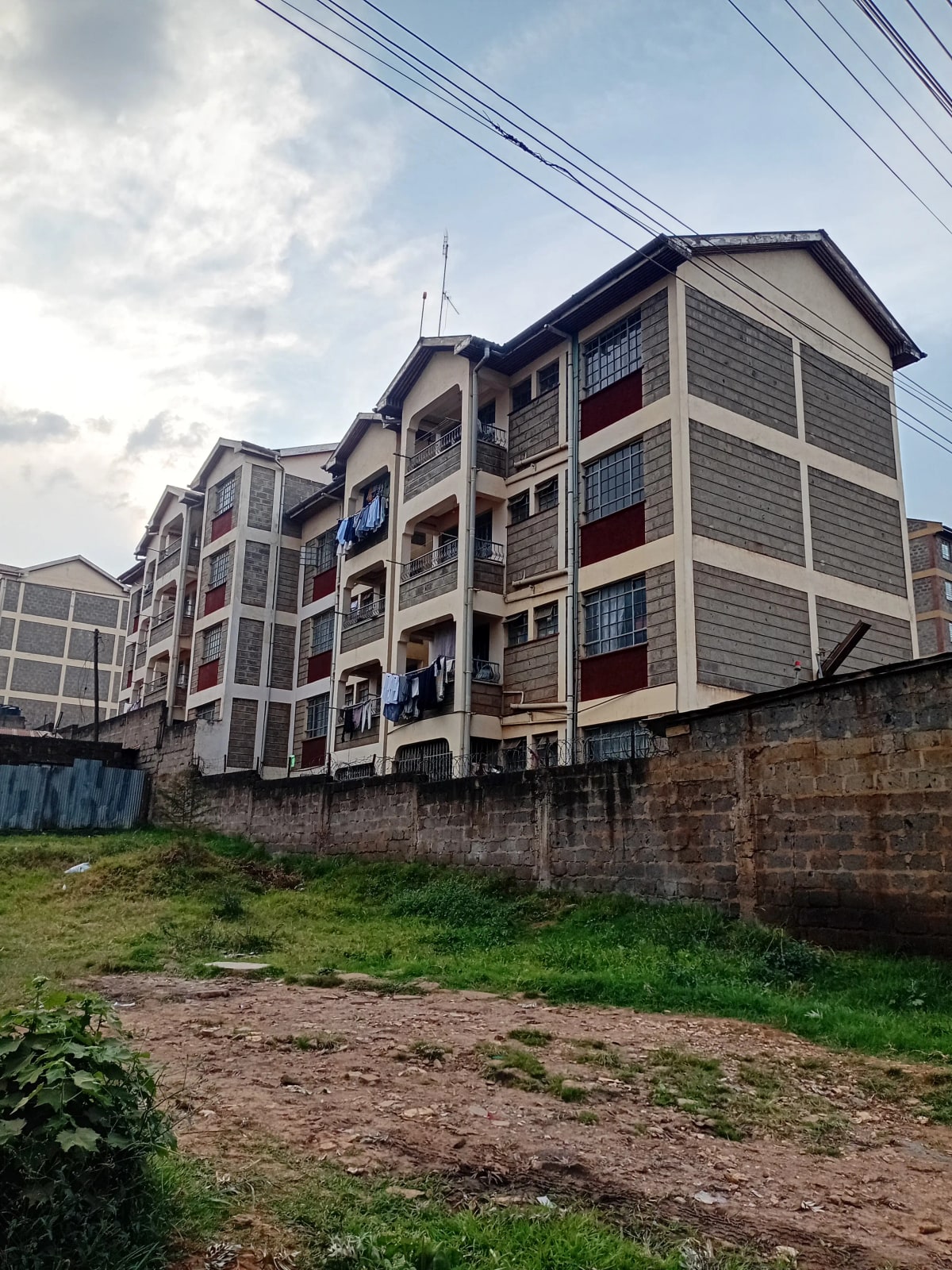 Multi-story residential building facade with gray and cream exterior