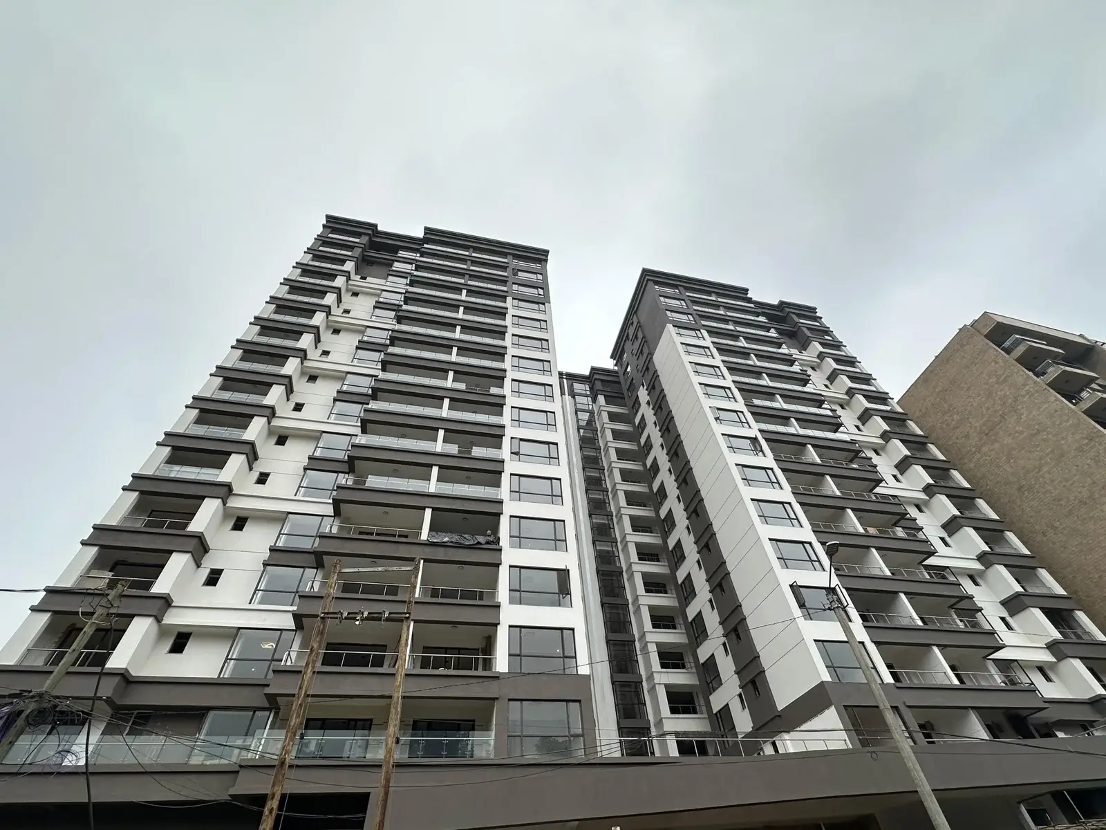 Modern multi-story residential building with balconies and facade