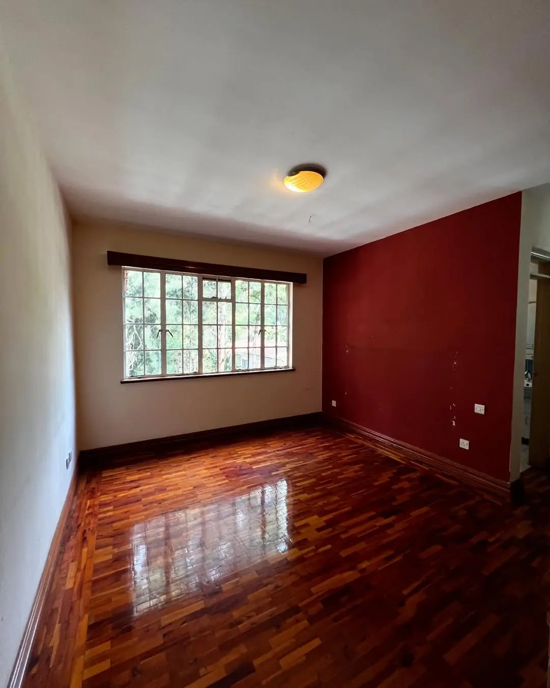 Spacious living room with hardwood floors and accent wall
