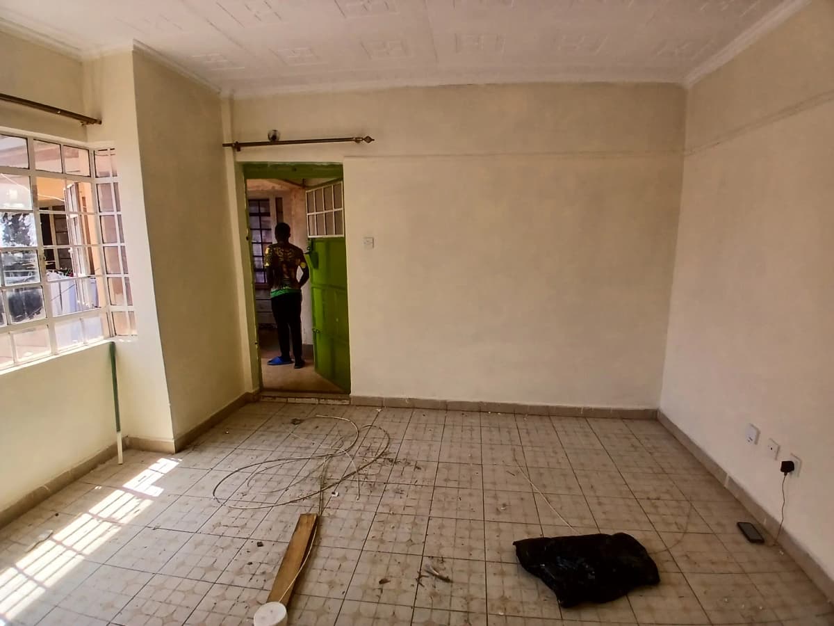 Empty living room with tiled floor and natural light