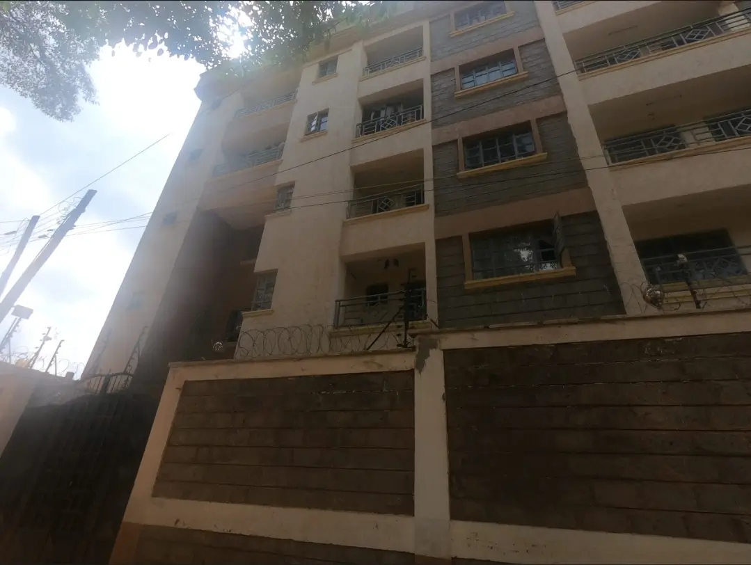 Multi-story residential building with wooden garage gates