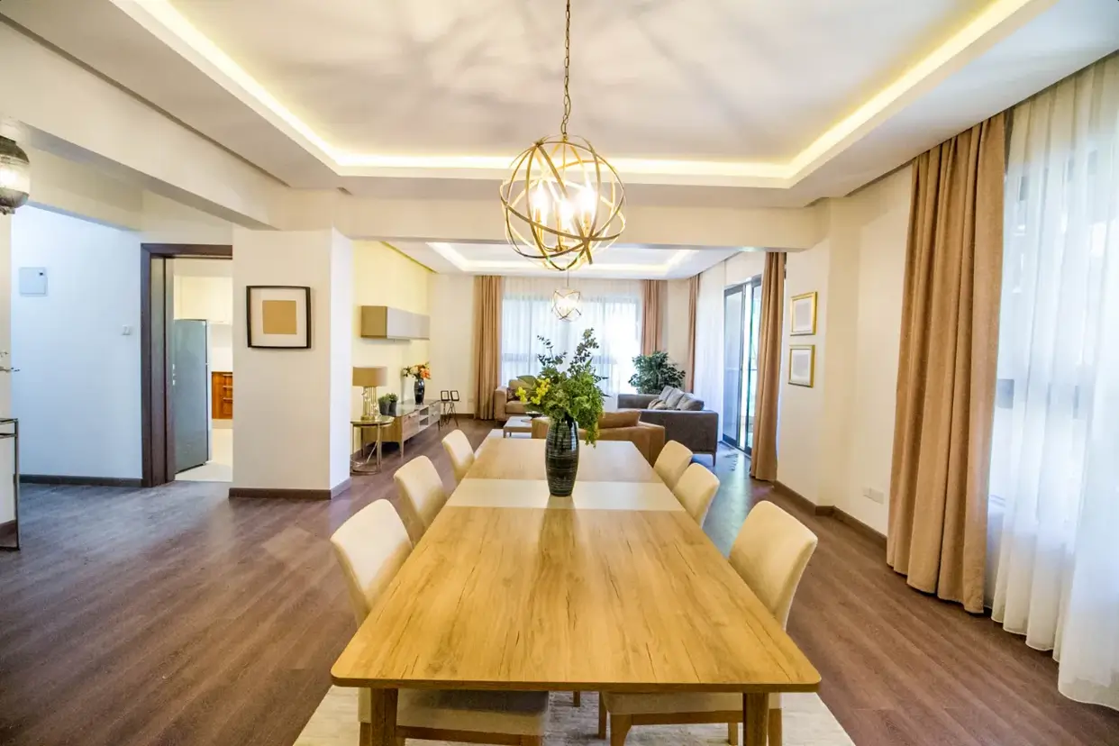 Spacious dining room with wooden table and modern pendant lighting