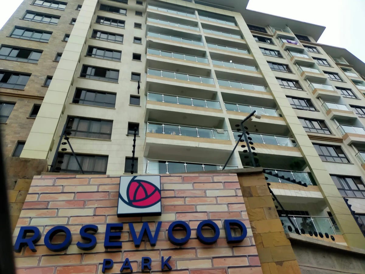 Multi-story residential building facade with balconies and signage