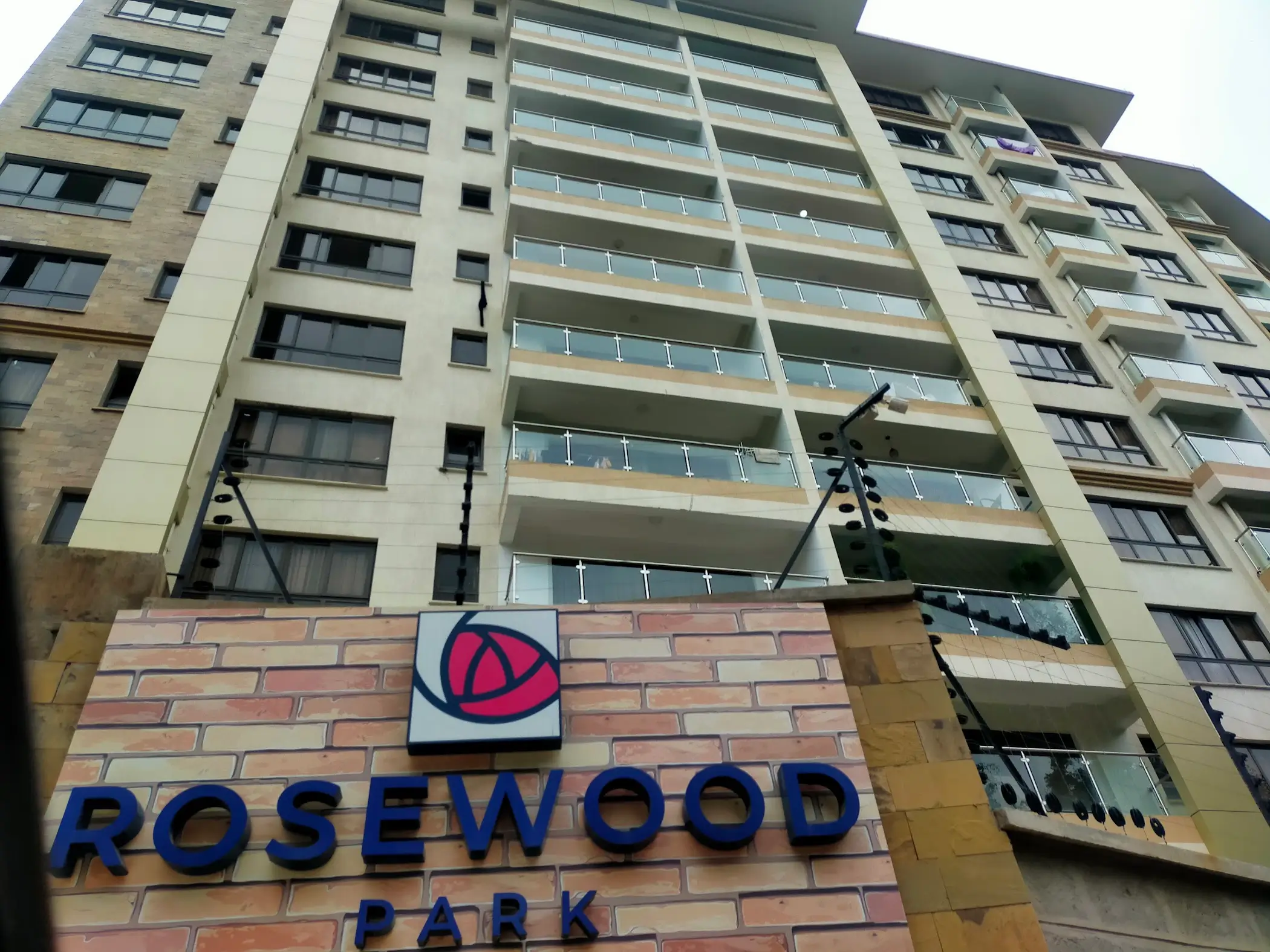 Multi-story residential building facade with balconies and signage