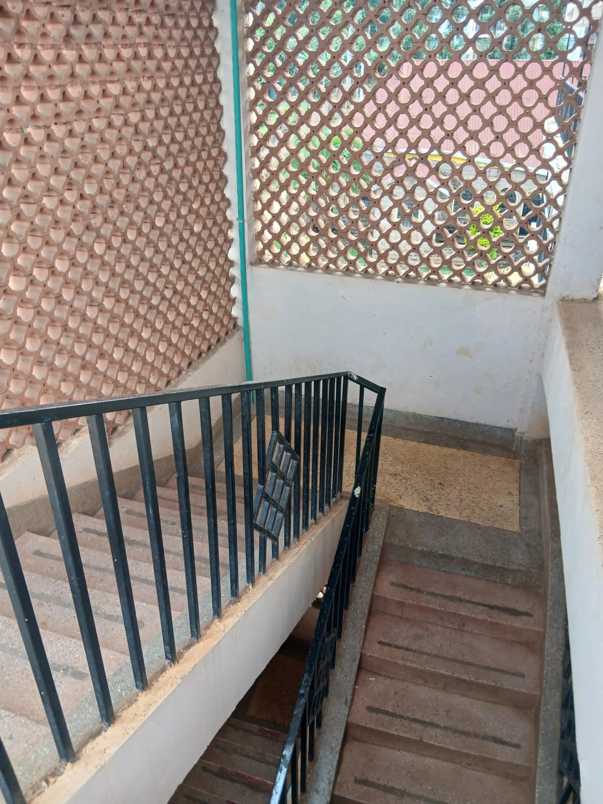 Interior stairwell with metal railing and lattice partition