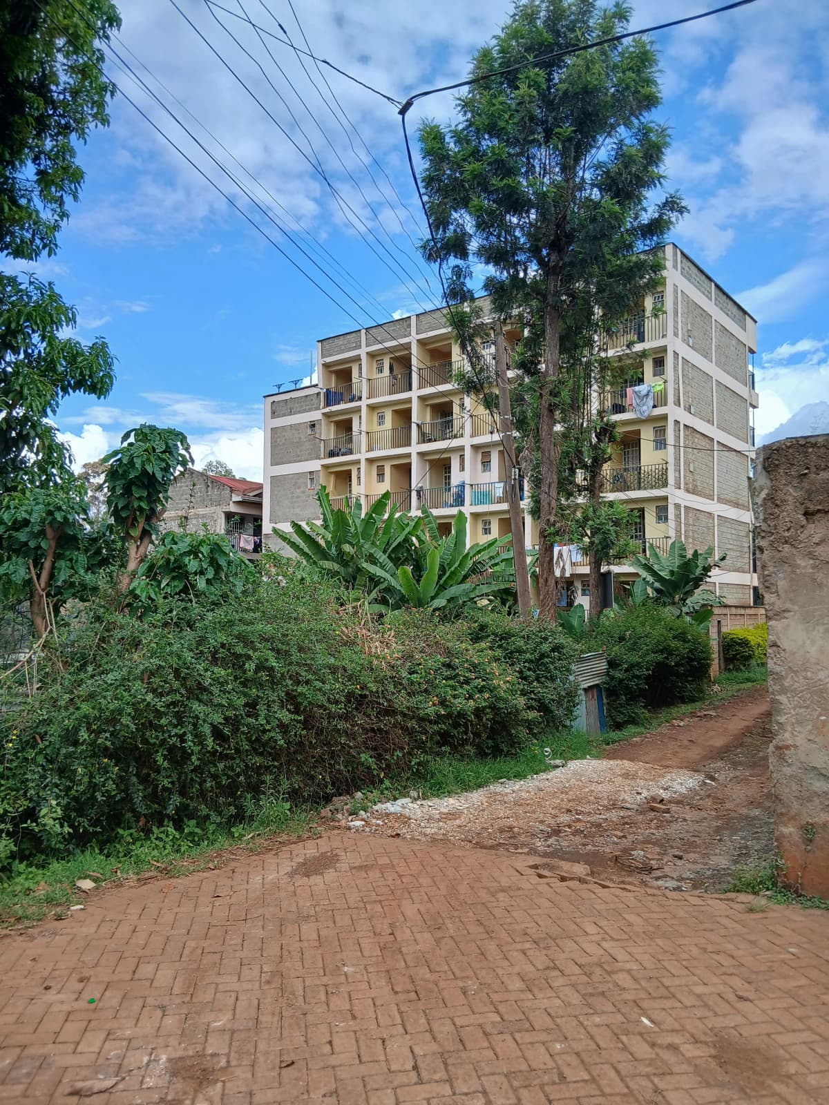 Multi-story residential building with brick driveway approach