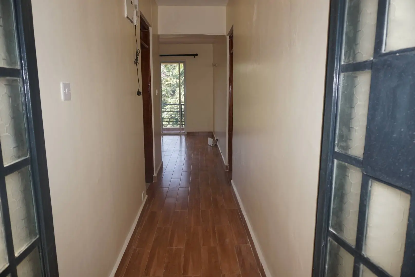 Long wooden hallway with natural light from window