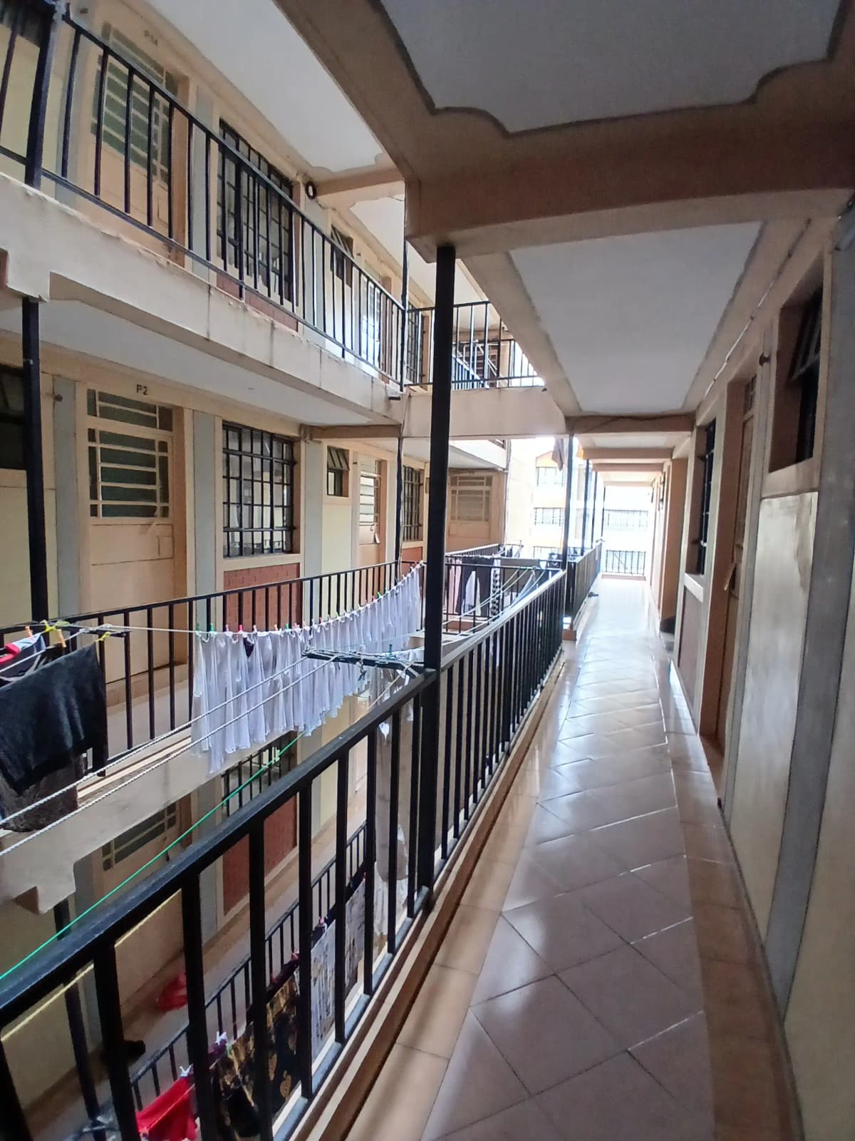 Multi-level interior corridor with railings and natural light