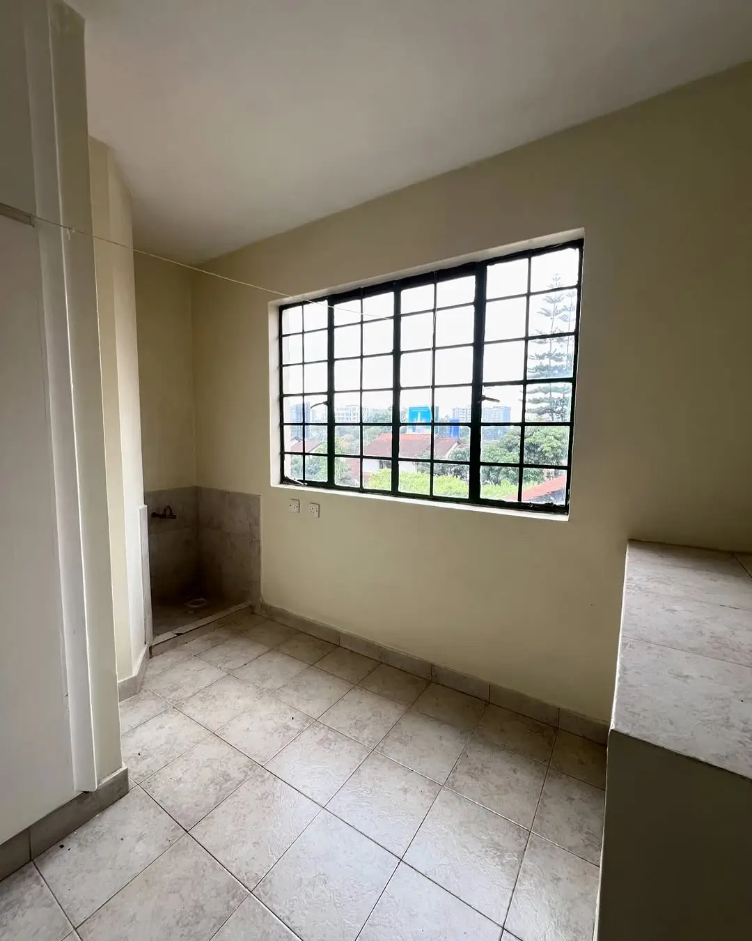 Unfurnished bedroom with grid window and tiled floor
