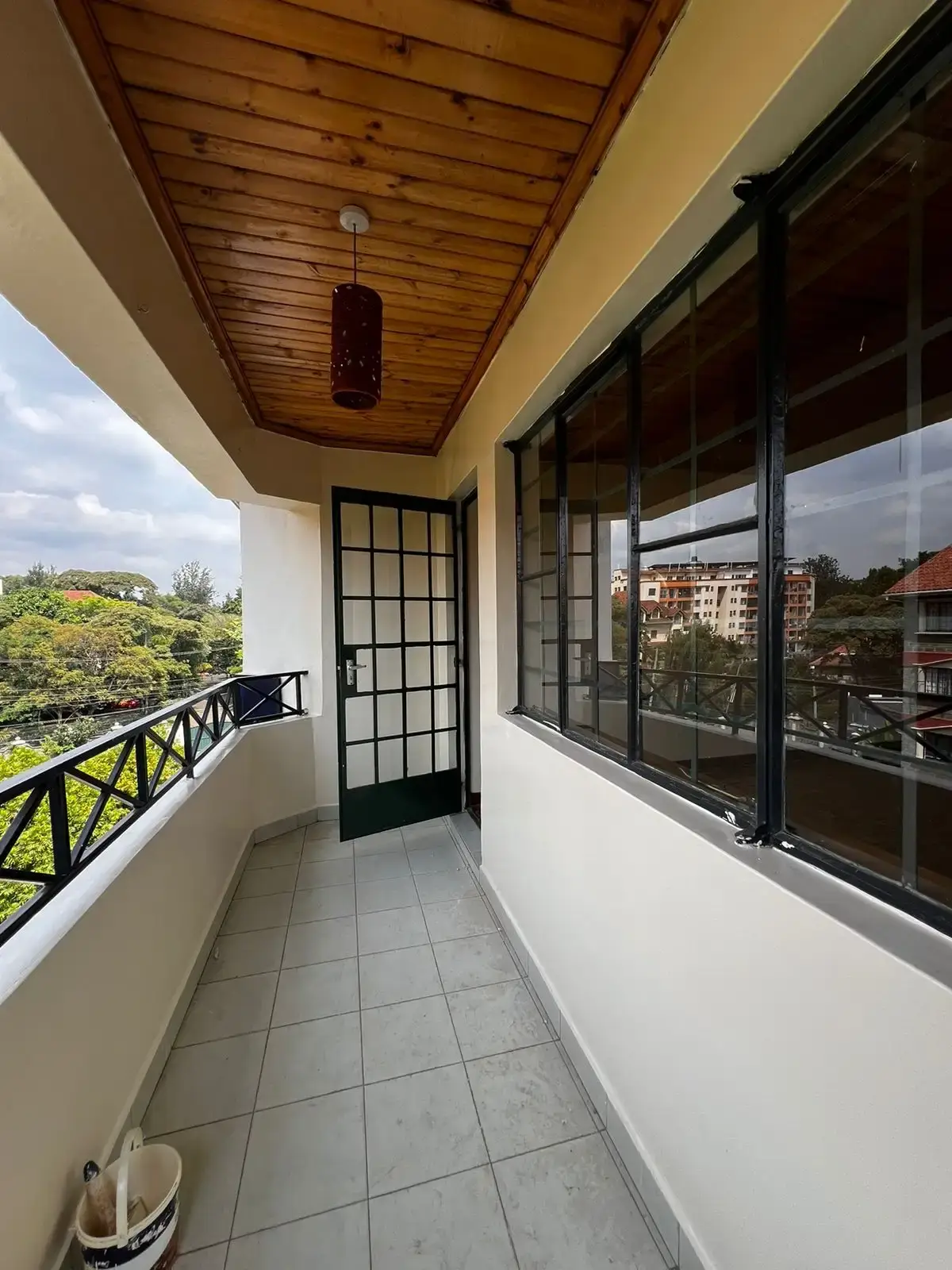Covered balcony with wooden ceiling and city views