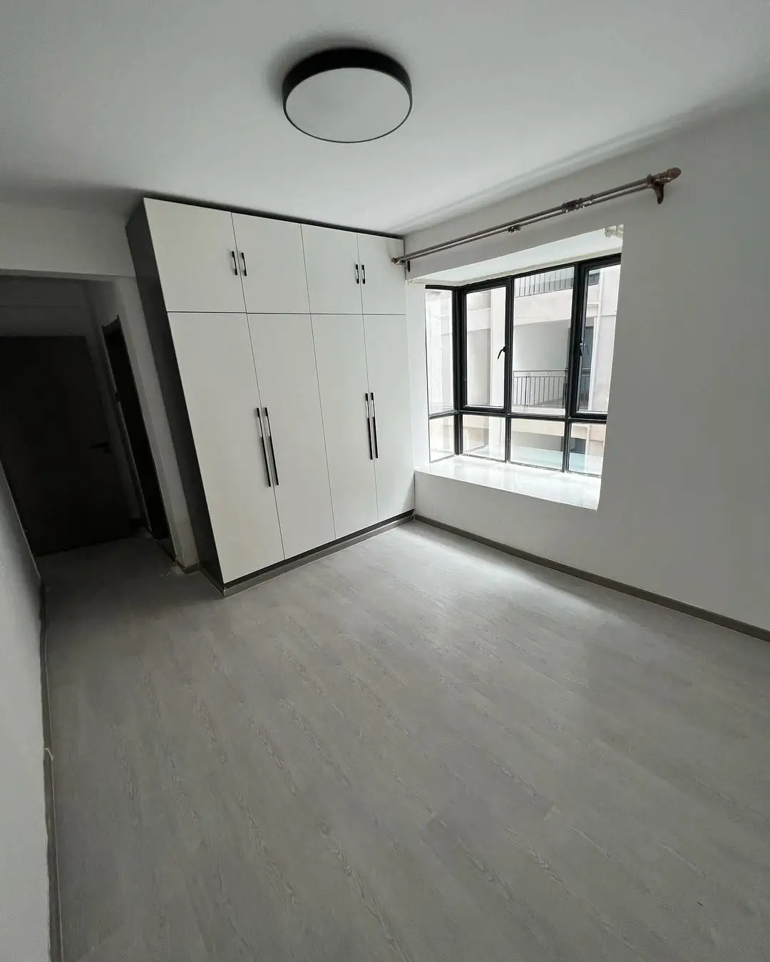Bright bedroom with built-in wardrobe and window view