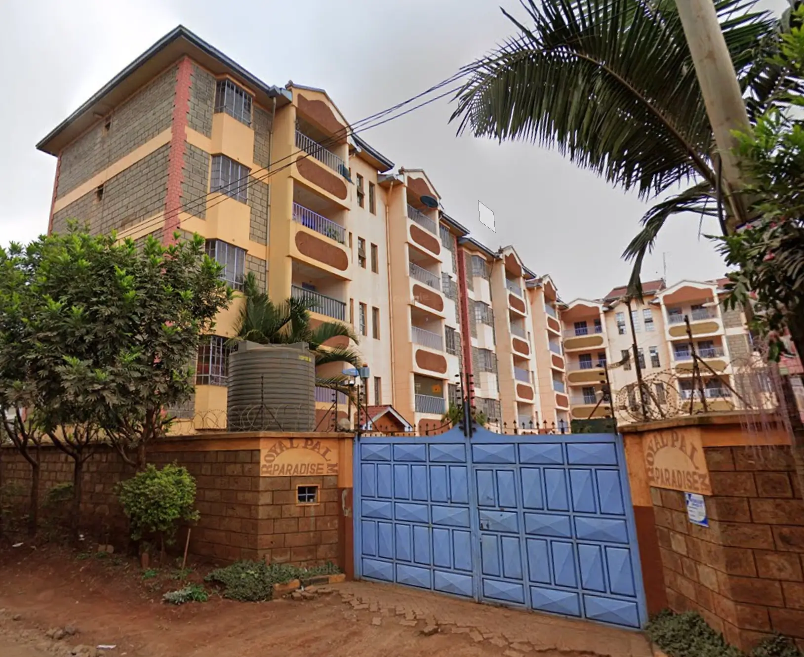 Multi-story residential building with gated compound entrance